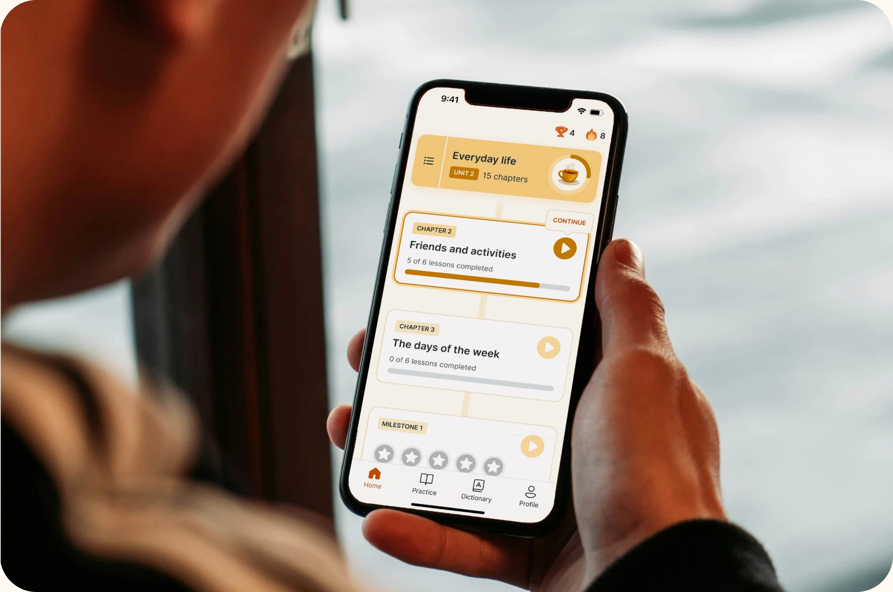 Person holding a phone with the Lingvano app open